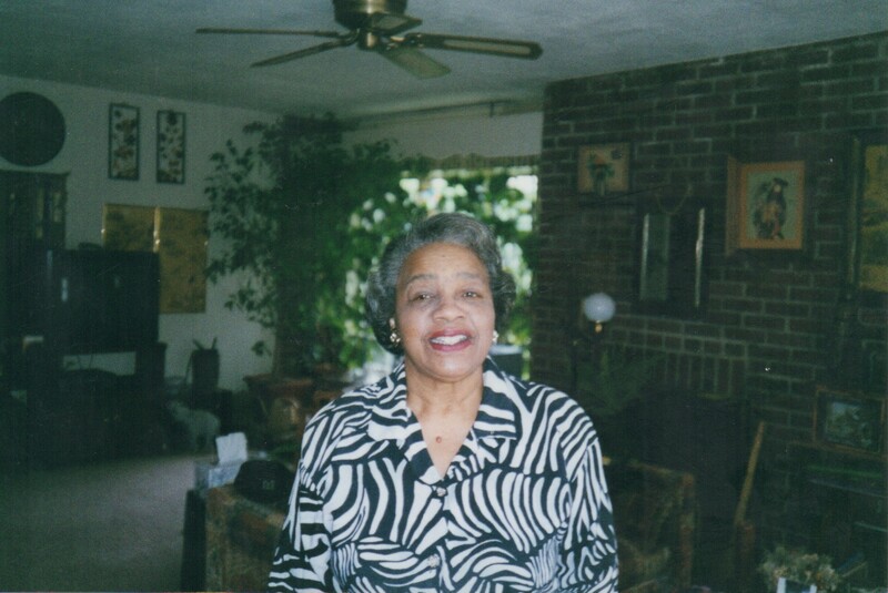 A woman posed for a photo in a living room.