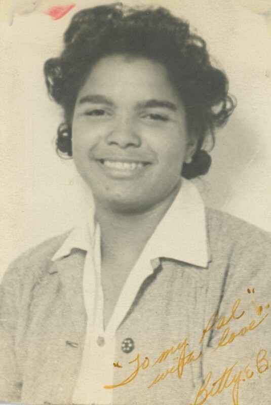 A young person smiling for a headshot photo.