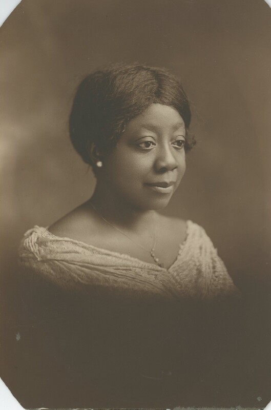 A person posing for a portrait from her shoulders up.