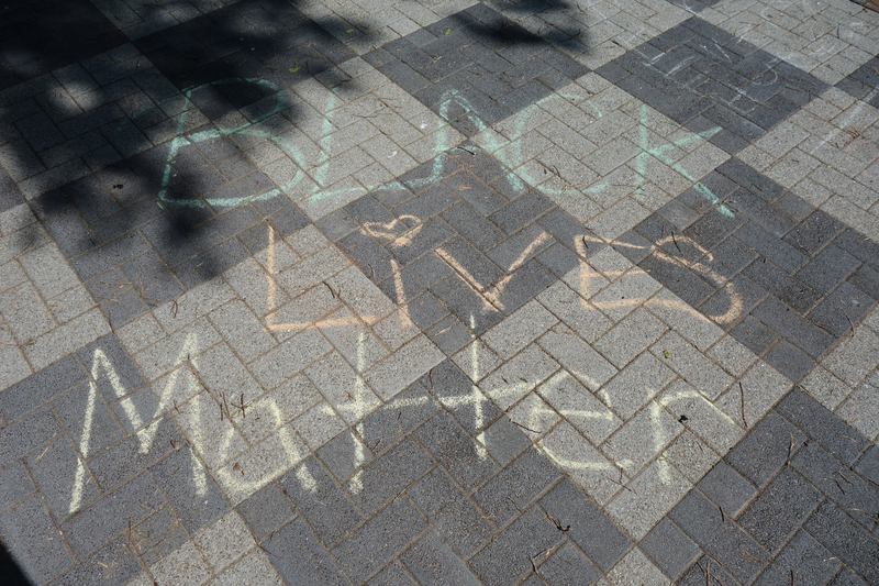Digital image (5472 x 3648). Snapshot of chalk writing in green, orange, and yellow on a walkway of grey pavers, “BLACK LiVES Matter.”  

Image taken on 6/4/2020 by Grout Museum District personnel. One of several such writings made in Waterloo’s Lincoln Park during the George Floyd Protest of 5/29/2020. Protest march began at Waterloo Veterans Memorial Hall and ended at Lincoln Park with speeches and declarations. Park was still under renovations when the protest was held.  Construction workers had to wash the chalk away before the paving could be sealed on 6/5/2020.   
