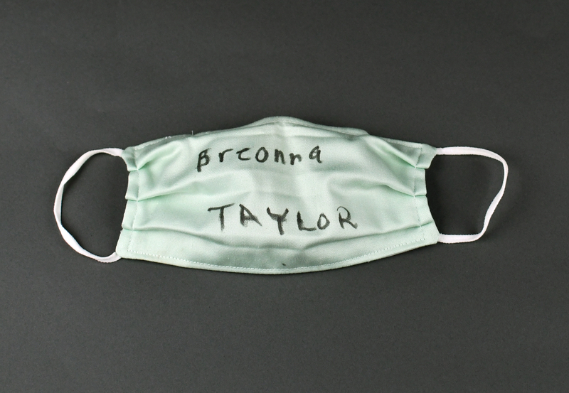 Covid mask of light green fabric. Hand-made. Machine-stitched. “Breonna TAYLOR” handwritten in black felt-tip marker at center anterior.   

Worn by Organizer Joyce Levingston during the 2020 George Floyd Protests in Waterloo, Cedar Falls, and the surrounding area.  Levingston herself organized (with others) the May 29 march from Veterans Memorial Hall to Lincoln Park in Waterloo.  Waterloo Courier photos depict Levingston wearing the mask at the June 6 vigil at Overman Park, Cedar Falls.  Mask also worn at the June 20 march from Clay St. to Overman Park in Cedar Falls.

From donor Joyce Levingston:

“When I heard George Floyd call out to his momma knowing he was going to lose his life, my heart shattered. It was at that moment that I knew in my lifetime I had seen this happen too much to my own. After hearing about Breonna Taylor and seeing what happened to George Floyd and many others in my lifetime I looked at my three daughters and my son and decided we need to come together in our community for all of our voices to be heard and mourn together for once instead of us carrying the weight on our own.  Rest in peace Breonna Taylor and rest in peace George Floyd.”