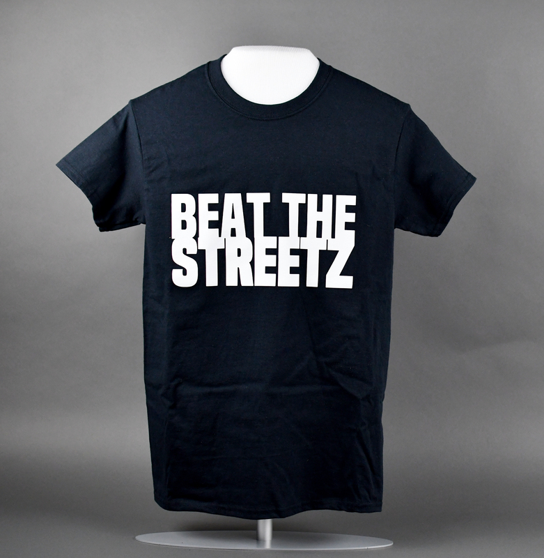 Crew-necked short-sleeve t-shirt of black cotton. Machine-stitched. “BEAT THE STREETZ” printed in white at center anterior.   

Beat the Streetz Foundation is a Waterloo nonprofit dedicated to providing education and resources to area youth, young adults, and adults for the prevention of gun violence. It’s founder, Raynelle Walker, is sister of local citizen Greg Walker, murdered 5/19/2018. The case remains unsolved. His nickname, “Streetz,” is the origin of the Foundation’s name.  
Beat the Streetz contributed to the organization of several Waterloo protests in 2020.