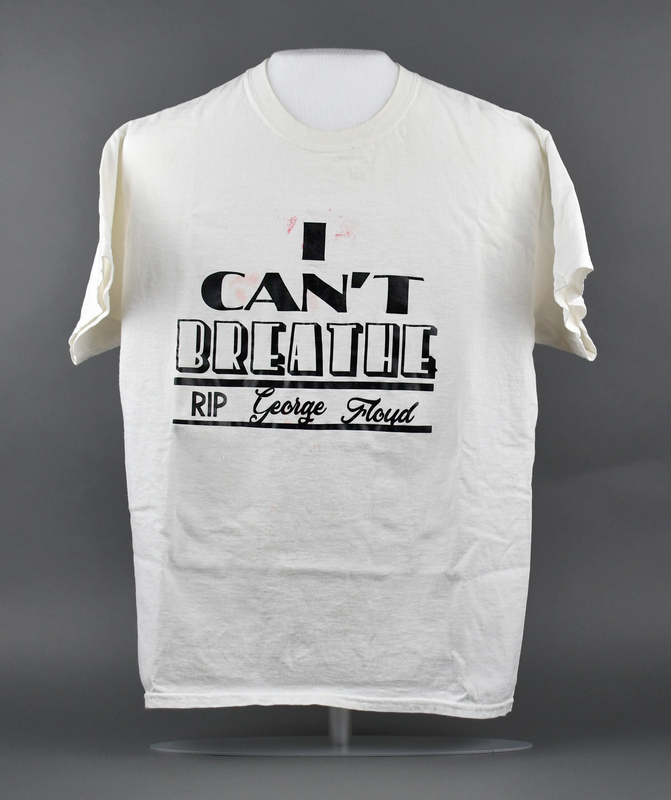 Crew-necked short-sleeve t-shirt of white cotton. Machine-stitched. “I CAN’T BREATHE, RIP George Floyd” printed in black at center anterior. “Rikki” printed in black at upper posterior.    

Worn by Organizer ReQuia Campbell during the 2020 George Floyd Protests in Waterloo. Campbell herself organized (with others) the May 29 march from Veterans Memorial Hall to Lincoln Park in Waterloo.
