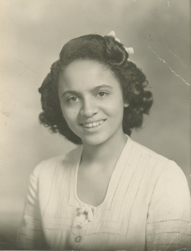 A young person smiling for a headshot portrait.