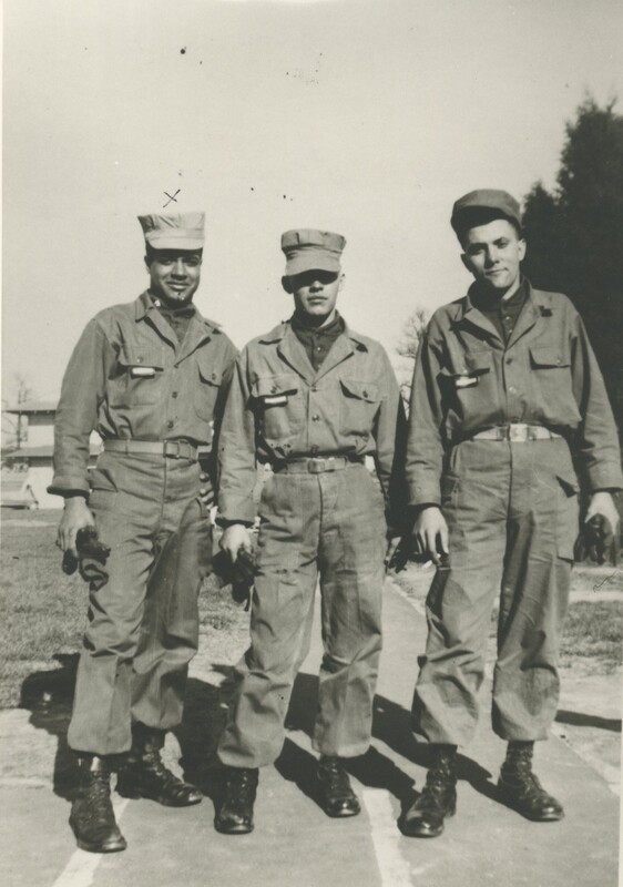 Three men standing next to each other smiling for a photo while wearing their military uniform.