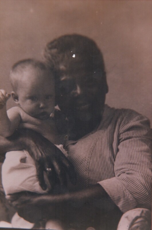 A person and a baby next to their face for a photo from the shoulders up.
