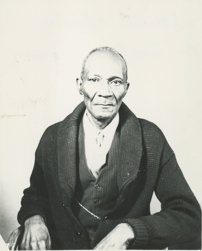 An older person sat for a portrait.