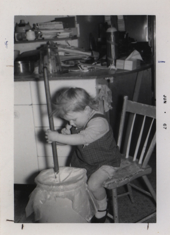 Photograph of Pegge Kruse, churning butter. Peggy, is the daughter of Harold Kruse, NFO Publicity Chairman of Sauk Co., WI.
