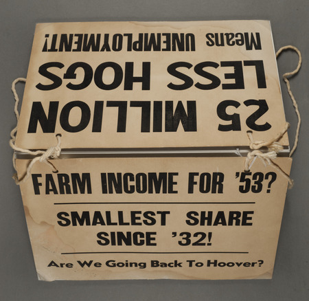 Picket sign from the Iowa Farmers Union. One side reads, "Farm Income '53? Smallest Share since '32! Are We going Back to Hoover?" The other side reads, "25 Million Less Hogs Means Unemployment."
