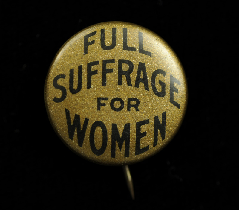 Round gold colored button with "FULL SUFFRAGE FOR WOMEN" in black lettering on the front.