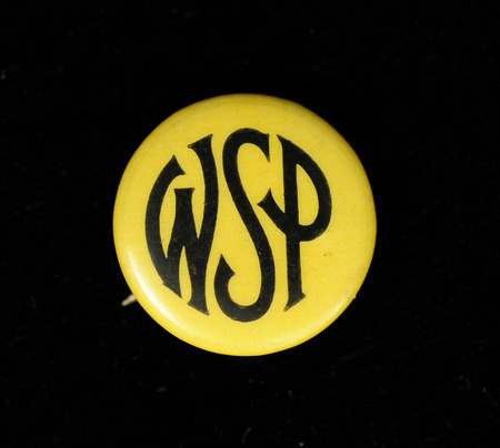 Round yellow button with "WSP" in black lettering on the front of it.