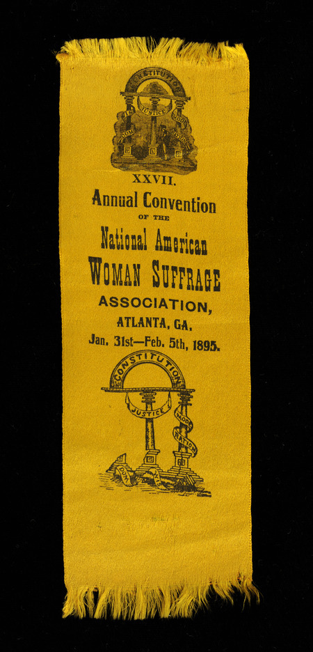 Gold colored ribbon with "XXVII Annual Convention of the; National American WOMAN SUFFRAGE ASSOCIATION, ATLANTA, GA. Jan. 31st-Feb. 5th, 1895" inscribed in black. The ribbon also includes two images; the top is of three columns representing wisdom, justice, and moderation upholding an arch representing the Constitution. The bottom image is similar to the first except the wisdom column has fallen to the ground. There is fraying at top and bottom of the ribbon.