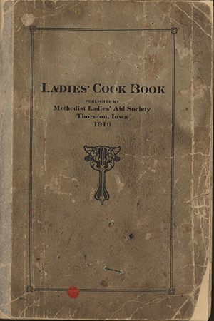 This cookbook compiled by the Methodist Ladies’ Aid Society in Thornton, Iowa includes advertisements, handwritten recipes, and recipe clippings.