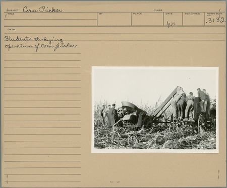 Students studying operation of corn picker.