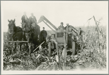 Students studying operation of corn picker.