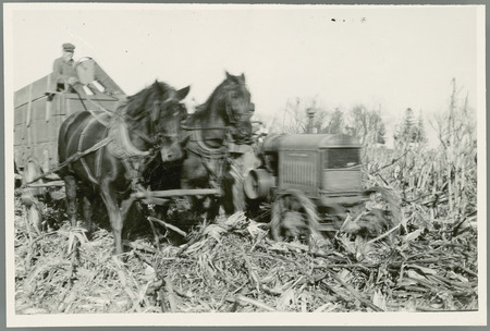 Students studying operation of corn picker.