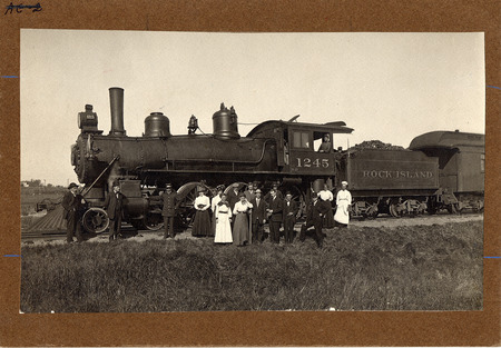 Photograph taken in 1910 of a Bacon Special Train with its crew standing next to the tracks.