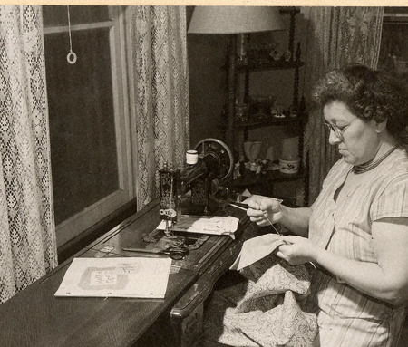 Photograph with a caption that reads: "Mrs. Flora Garber sewing after watching Make-A-Dress TV." Taken in 1952.