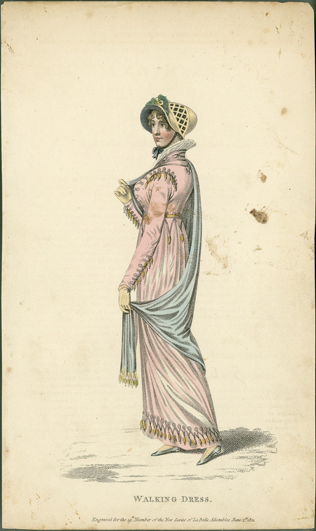 Walking Dress, with ribbing on the hem, sleeves and shoulders, a cape, and an Elizabethan collar. There is also a bonnet framing the face, decorated with ribbing and flowers.