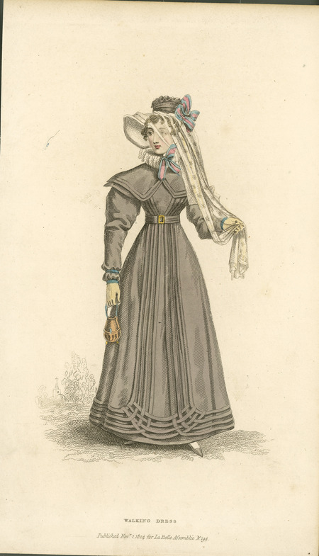 Walking Dress, showing a redingote (or pelisse), with mameluke sleeve (widening shoulders), the Betsy collar (Elizabethan revival ruffle), the emphasis on the waist with a belt, decoration at the ends of the sleeves, the emphasis of decoration on the lower hem, headwear including a veil and ribbons, gloves, and purse published for La Belle Assemblee).