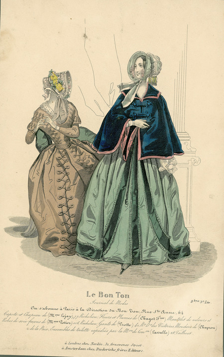 Two walking dresses, both have long, full skirts and face framing bonnets trimmed with feathers, flowers and lace. Left dress has a lace collar, fitted long sleeves with extended shoulders, and a narrow waistline. Right has a capelet draped around upper body and arms with military-style closures. (Published for Le Bon Ton by Nardin, London).