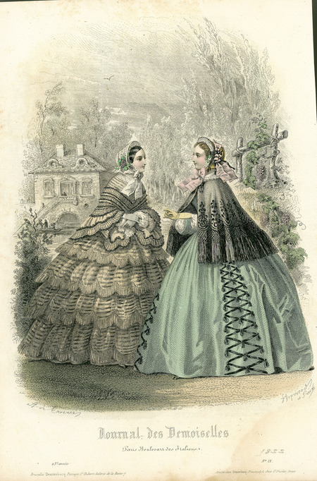 Two walking dresses, both show a wider silhouette with extremely full skirts, capes, and bonnets trimmed with ribbons, lace, and grapes on the left one. The left dress appears to have a fitted bodice with lace color and matching wrap with ruffled edges, long sleeves with lace trim near the wrists, and a full skirt with numerous flounces. The right outfit has a cape with an intricate design and fringe along the edge over a dress with a lace collar, long sleeves trimmed in lace, and a skirt trimmed with rickrack and tassels. (published for Journal des Demoiselles, No IX).