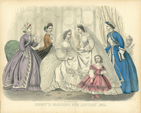 Wedding party showing 2 wedding dresses and 3 other dresses all with jewel necklines, long sleeves and hoop skirts. Both wedding gowns have center front buttons, small lace collars, loose sleeves with ruffle trim, and full length veils attached to flowers atop each bride's head. The woman on the far left has a bolero jacket with coat style sleeves, ruffle cuffs, a button front vest, a layered skirt with pockets, and a lace cap. The woman on the far right has a bolero jacket with pagoda sleeves, a lace trimmed blouse, a trimmed skirt with pockets, and a lace cap. The final woman has a fitted bodice with long sleeves, a small lace collar, a lace cap, and a shawl. The girl has a layered bodice with a square neckline; long, full sleeves; and a short, full skirt. (published for Godey's Fashions by Kimmel & Forster, New York).