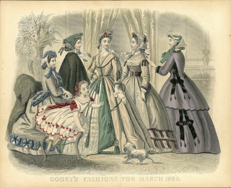 Five day ensembles all with long sleeves, fitted bodices, full skirts, and a variety of lace caps. The seated woman is in plaid with trimmed basques matching the trim around the bottom of the skirt. The 2nd woman is in a cloak or mantle. The center woman (#3) has a square neckline, braid and tassel trim on her dress and around her waist, and a layered skirt that opens in center front to reveal a lace underskirt. The 4th woman has a simpler dress with a small collar, a wide belt, and minimal trim. The woman on the far right (#5) has a semi-fitted coat that matches her skirt with ribbon and tassel trim. The girl is wearing a square necked dress with short sleeves and a full skirt, all trimmed with ribbons and lace. (published for Godey's Fashions by Kimmel, New York).