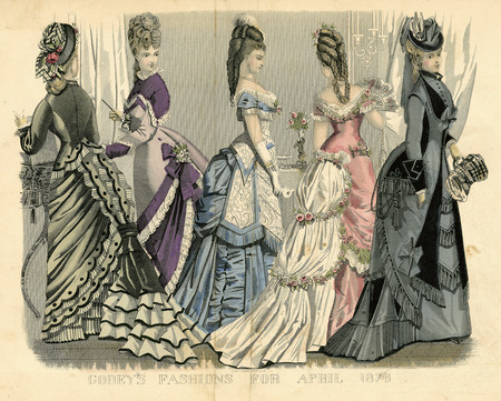 Three day and two evening dresses all with bustles and multiple flounced, ruffled, and tasseled overskirts gathered with bows and flowers several times to form trains. Day dresses have band collars, long sleeves with wide cuffs, fitted bodices, and two wear hats with flowers, birds and draped fabric. Evening dresses have wide rounded necklines, short sleeves, hair decorated with flowers and feathers, elbow length gloves. All dresses heavily embellished and all women's hair is piled high atop their heads. (published by Godey's Fashions).