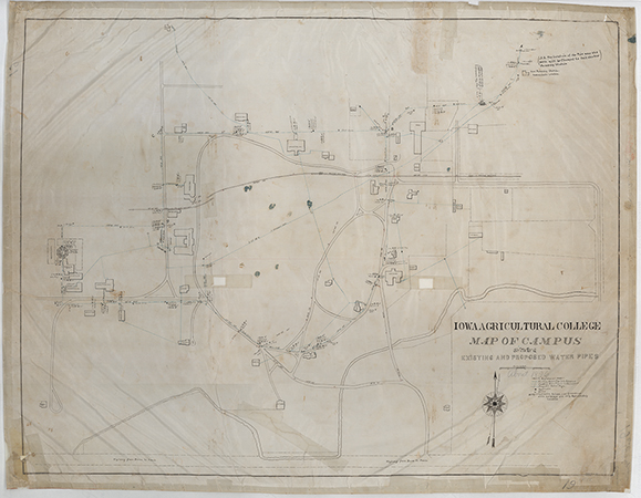 Map of the campus of Iowa Agricultural College showing the locations of existing and proposed water pipes.