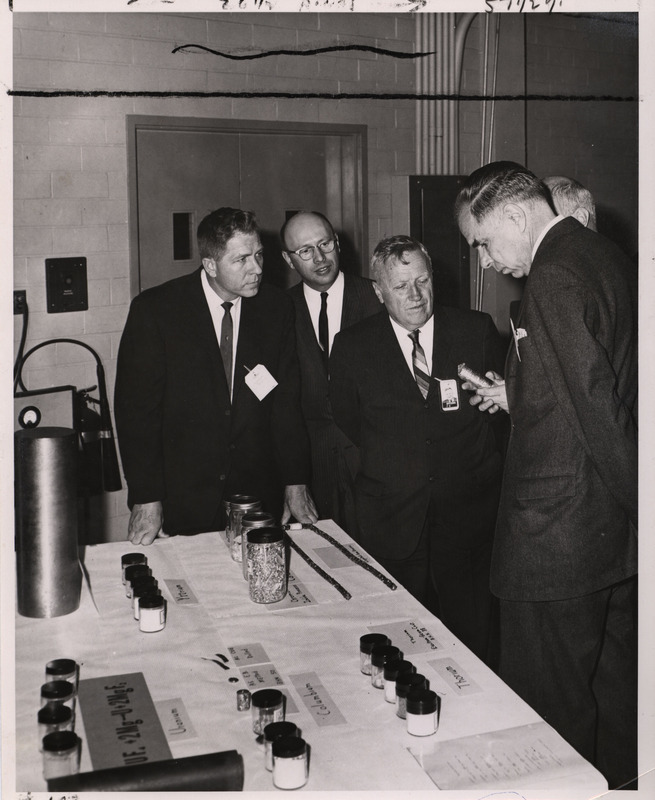Annotation: "(L to R) Congressman Neal L. Smith (Iowa) Dwight A. Ink, Assistant General Manager, AEC, Frank H. Spedding, Director, Ames Laboratory, and Chairman Glenn T. Seaborg examine metals produced in the Ames Laboratory. Photo by Ames Lab U.S.A.E.C. ISU Ames, Iowa"