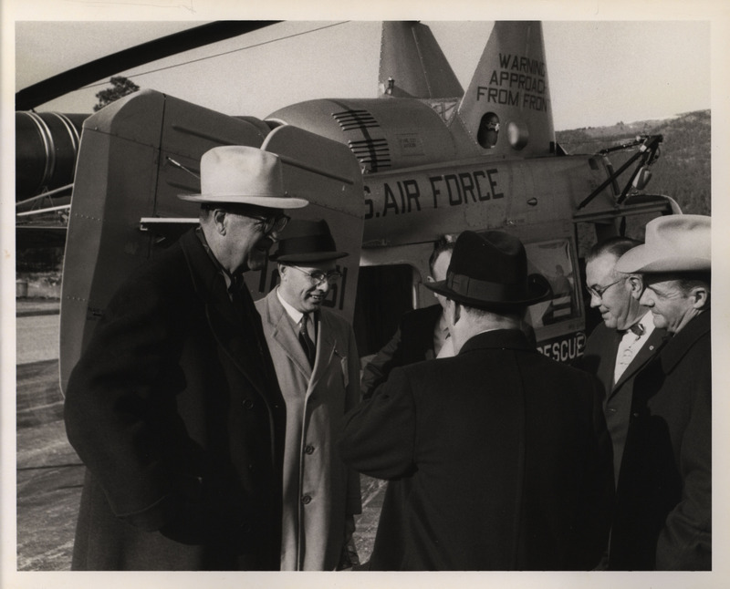 Photograph of Dwight Ink with others near an aircraft