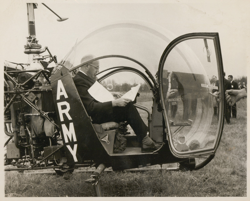 Photograph of Dwight Ink sitting in a helicopter