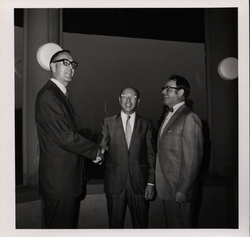 Photograph of Dwight Ink with a group of people during the "Honoring Glenn V. Gibson" event