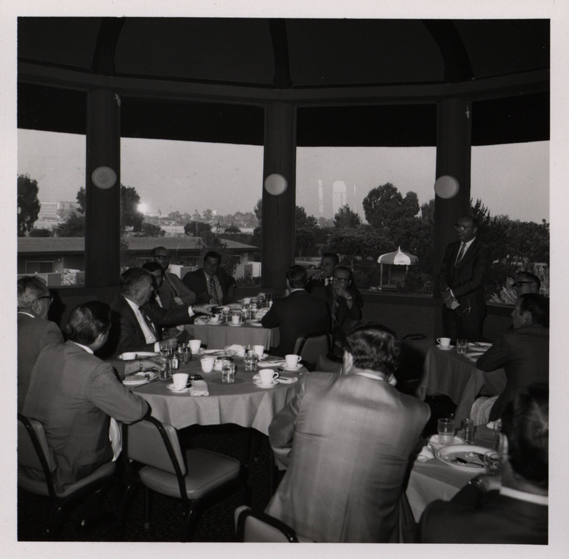 Photograph of people sitting around tables during the "Honoring Glenn V. Gibson" event