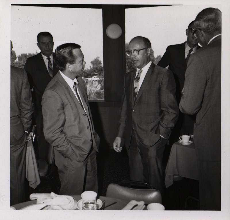 Photograph of Dwight Ink with a group of people during the "Honoring Glenn V. Gibson" event