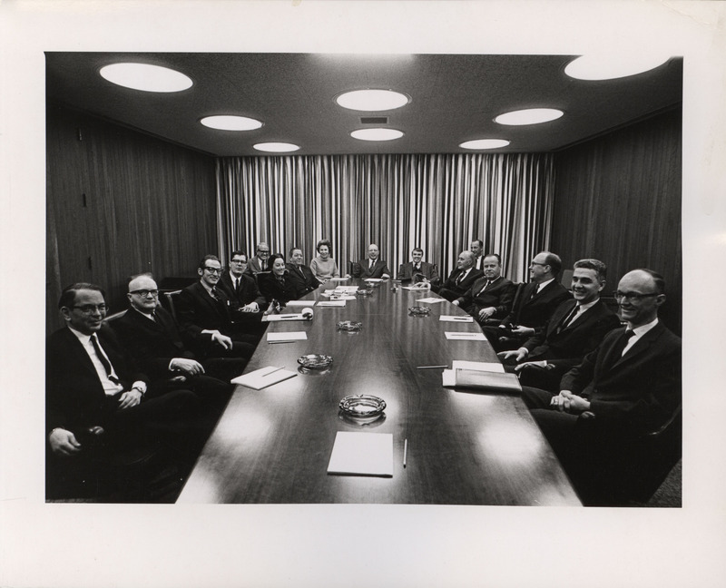 Photograph of Dwight Ink with a group of people sitting around a table