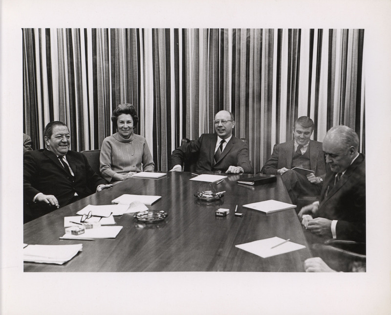 Photograph of Dwight Ink with a group of people sitting around a table