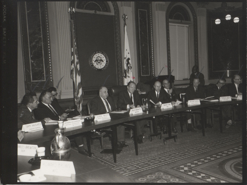Photograph of Dwight Ink with others sitting around tables at the Indian Treaty Room