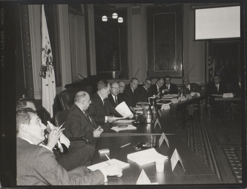 Photograph of Dwight Ink with others sitting around tables at the Indian Treaty Room