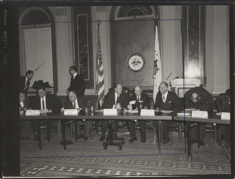 Photograph of Dwight Ink with others sitting around tables at the Indian Treaty Room