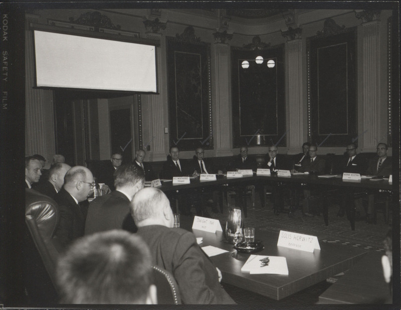 Photograph of Dwight Ink with others sitting around tables at the Indian Treaty Room