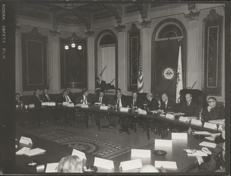 Photograph of Dwight Ink with others sitting around tables at the Indian Treaty Room