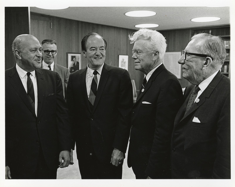 Photograph of Robert Weaver, Hubert Humphrey, and other men