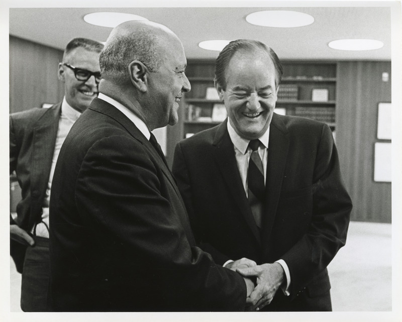 Photograph of Robert Weaver shaking hands with Hubert Humphrey