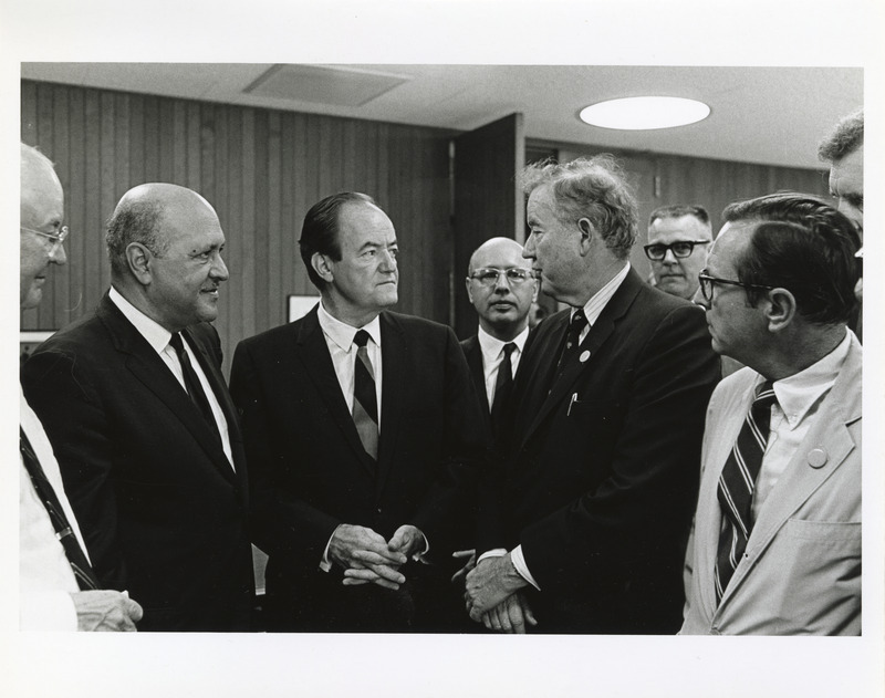 Photograph of Robert Weaver, Hubert Humphrey, Dwight Ink, and other men