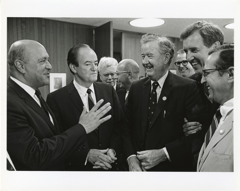 Photograph of Robert Weaver, Hubert Humphrey, Dwight Ink, and other men