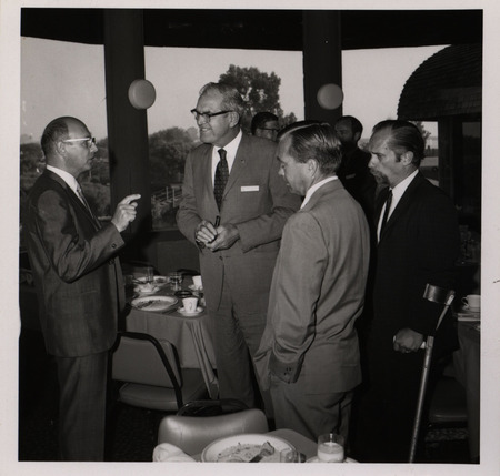 Photograph of Dwight Ink with a group of people during the "Honoring Glenn V. Gibson" event