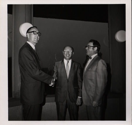 Photograph of Dwight Ink with a group of people during the "Honoring Glenn V. Gibson" event