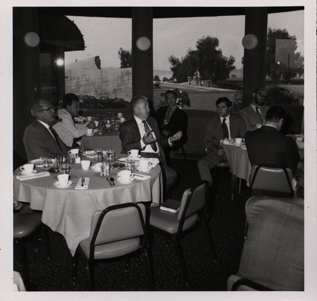 Photograph of people sitting around tables during the "Honoring Glenn V. Gibson" event